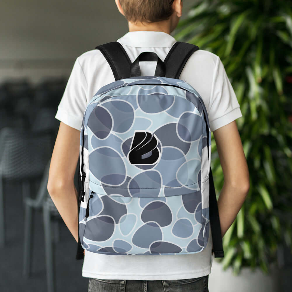 Person wearing Rucksack N°5 with abstract pattern design, ideal for daily use and sports, featuring waterproof material and laptop pocket.