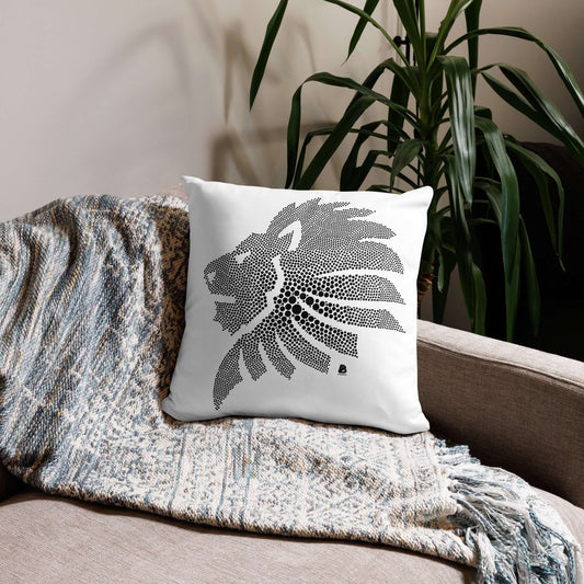 Basic-Kissen N°0 with lion design, placed on sofa, decorative and soft, enhancing room decor. Washable polyester cover, hidden zipper.