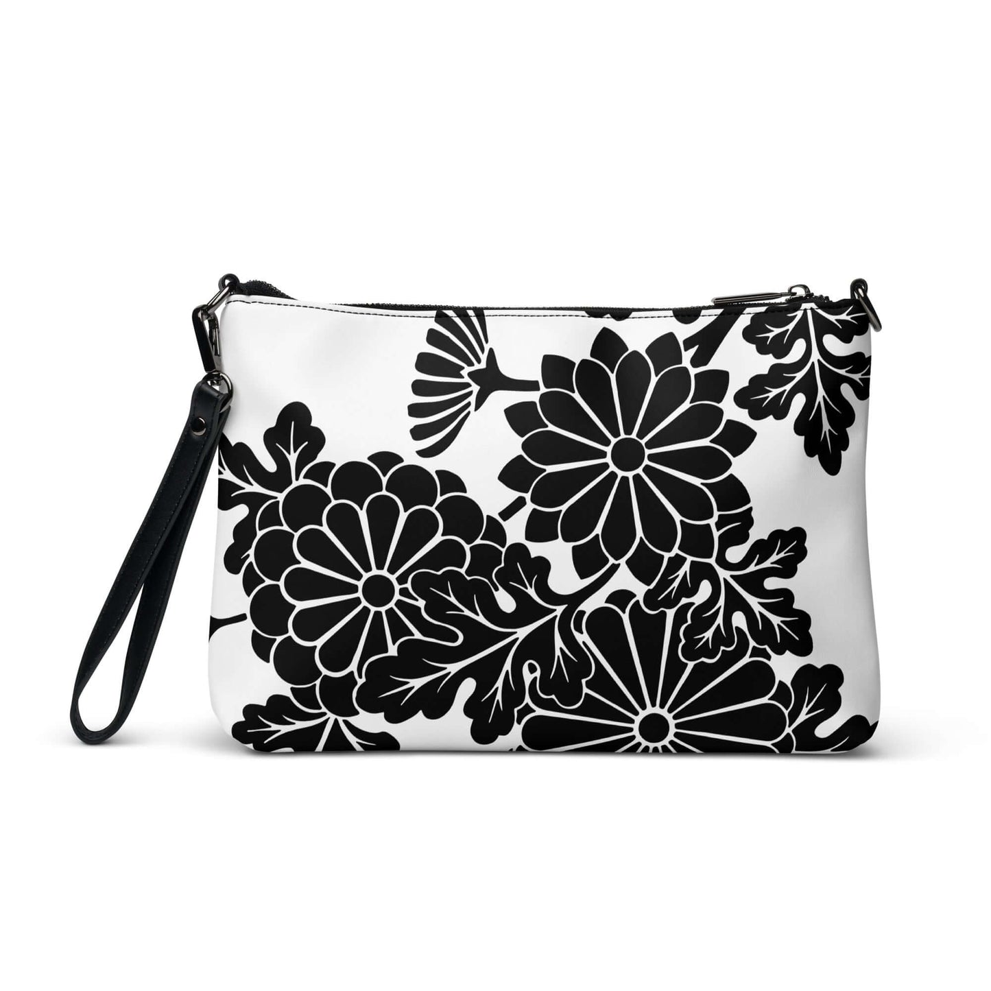 Stylish Umhängetasche N°1 with black floral design on white background, featuring detachable wrist and shoulder straps for versatility.