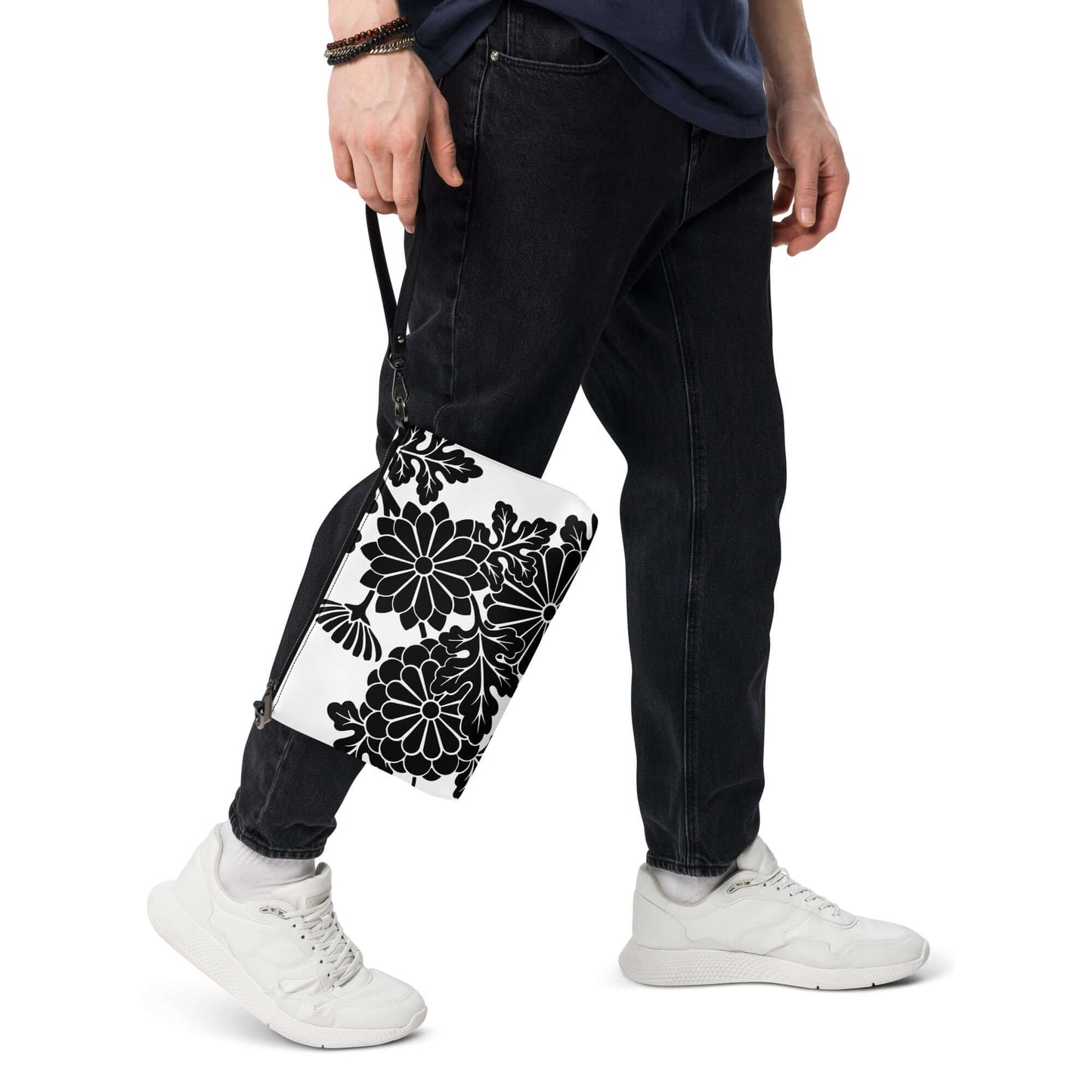 Person carrying Umhängetasche N°1, a versatile bag with black floral print, showcasing stylish hands-free convenience and removable strap.