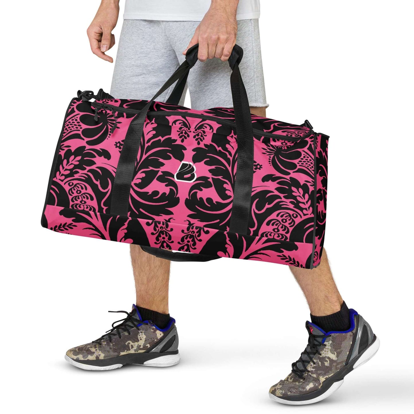 Person carrying stylish Weekender N°29 pink and black bag, ideal for travel, daily errands, or gym with adjustable shoulder straps.