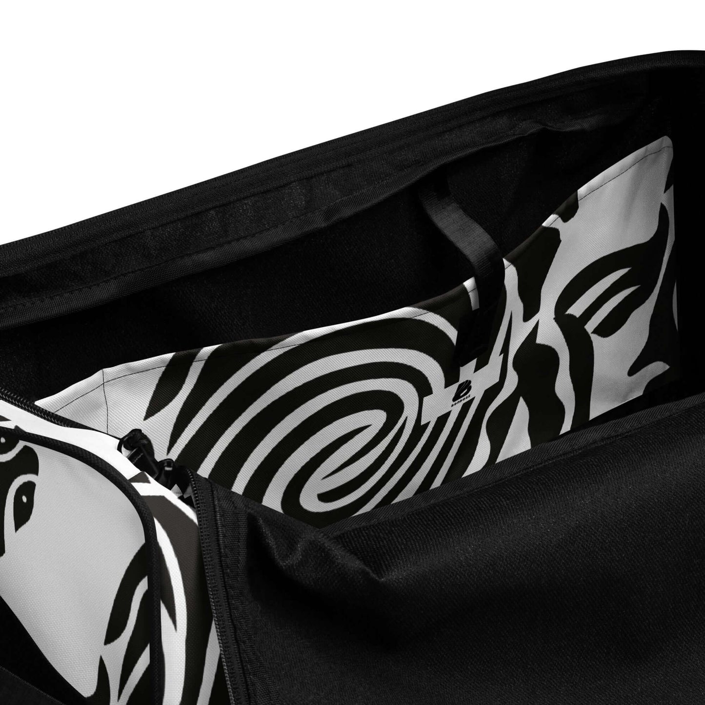 Interior view of Weekender N°28 showing spacious compartments with stylish black and white patterned lining ideal for belongings.