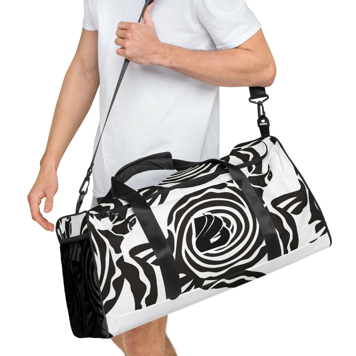 Man carrying black and white patterned Weekender N°28, showcasing spacious design and adjustable shoulder straps for travel or gym use.