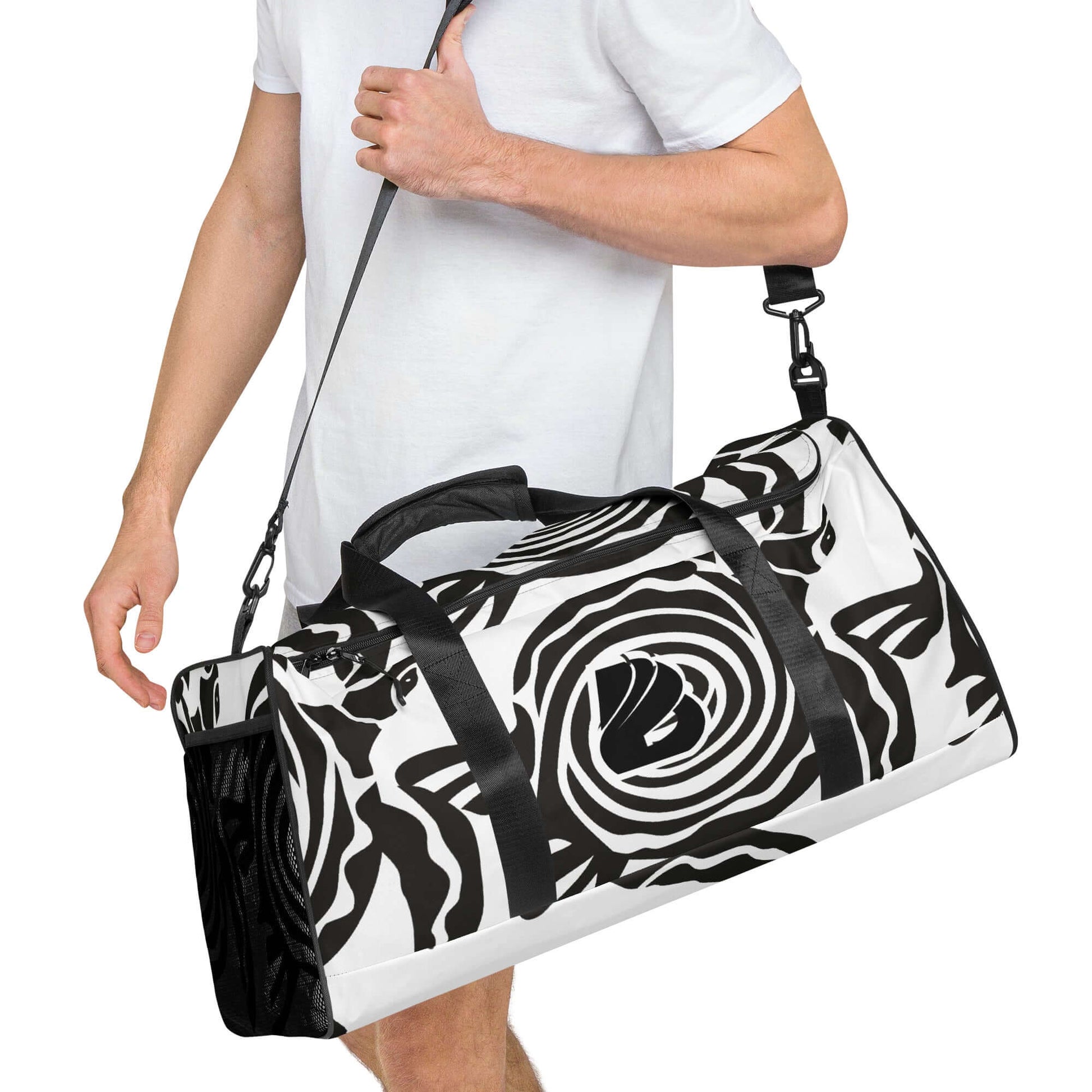 Man carrying black and white patterned Weekender N°28, showcasing spacious design and adjustable shoulder straps for travel or gym use.
