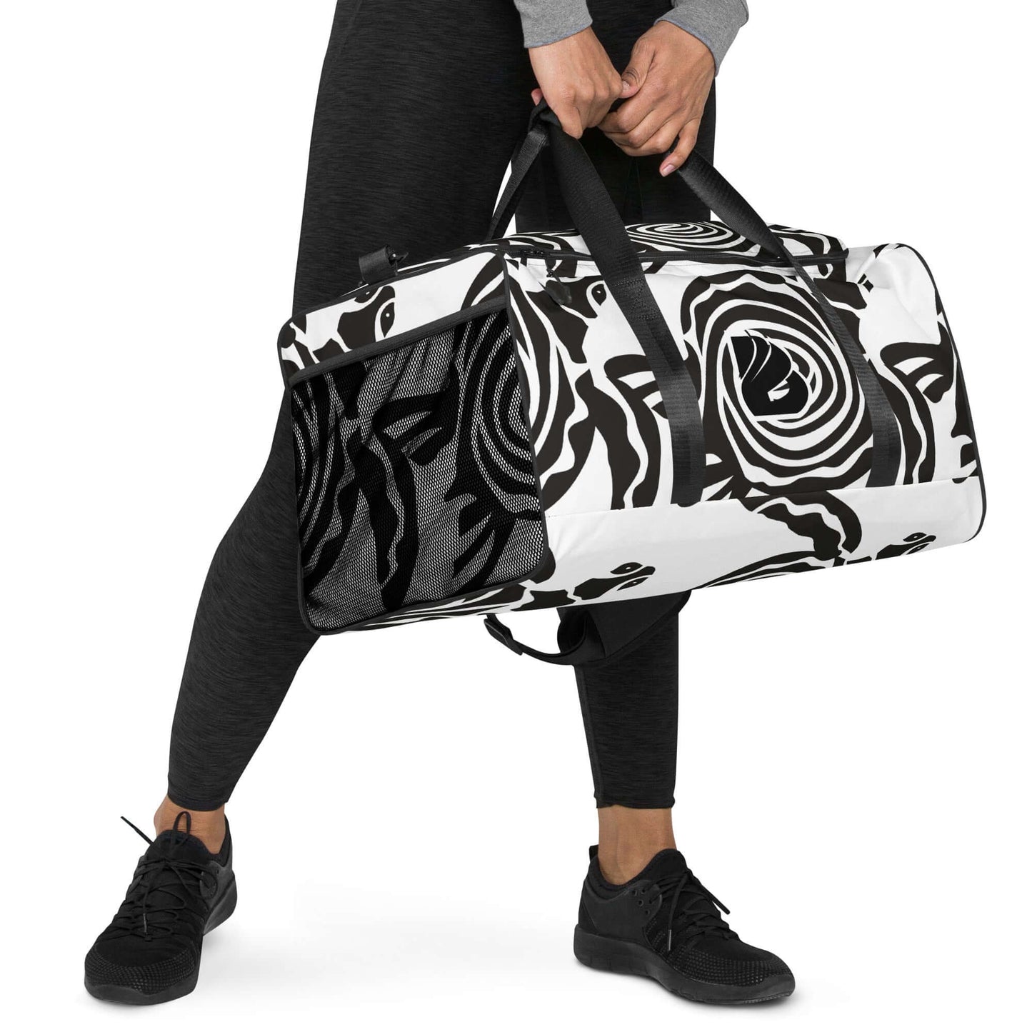 Person carrying Weekender N°28 with black and white abstract pattern; spacious travel bag with adjustable shoulder straps.