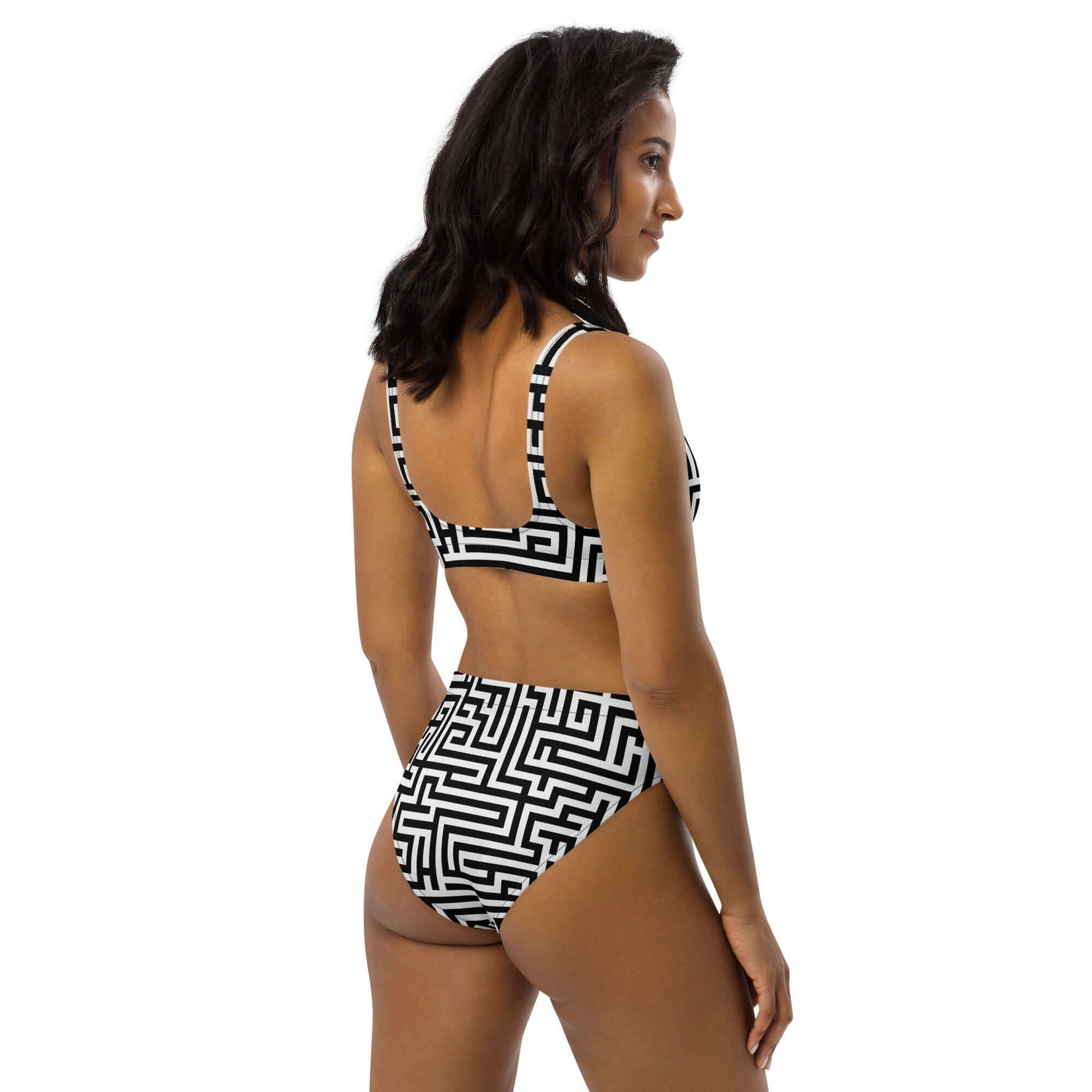 Model wearing Recycelter Allover High Waist Bikini N°2 with black and white geometric pattern, rear view.