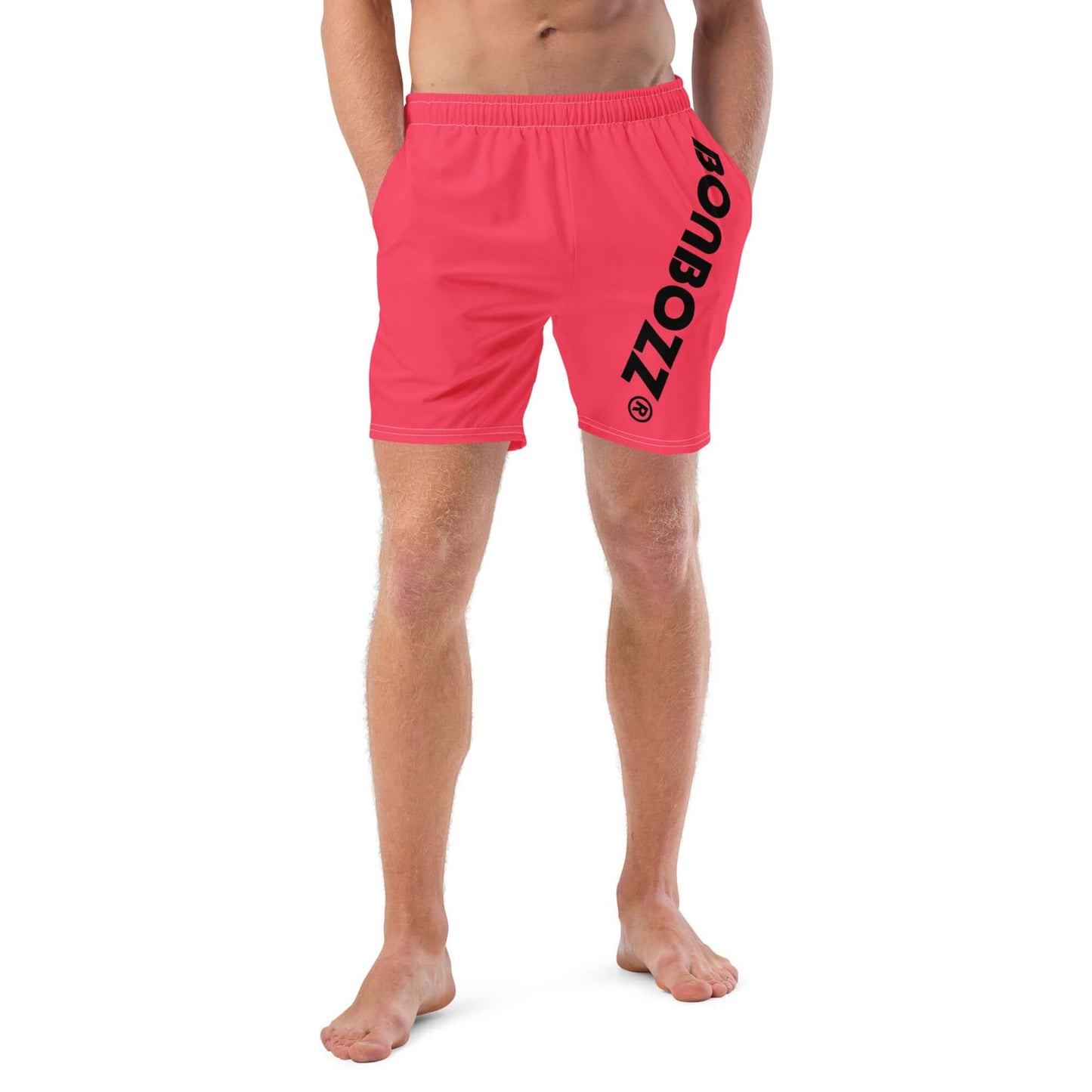 Model wearing Herren-Badehosen N°13 red swim trunks with logo, featuring quick-dry, breathable fabric, and multiple pockets.