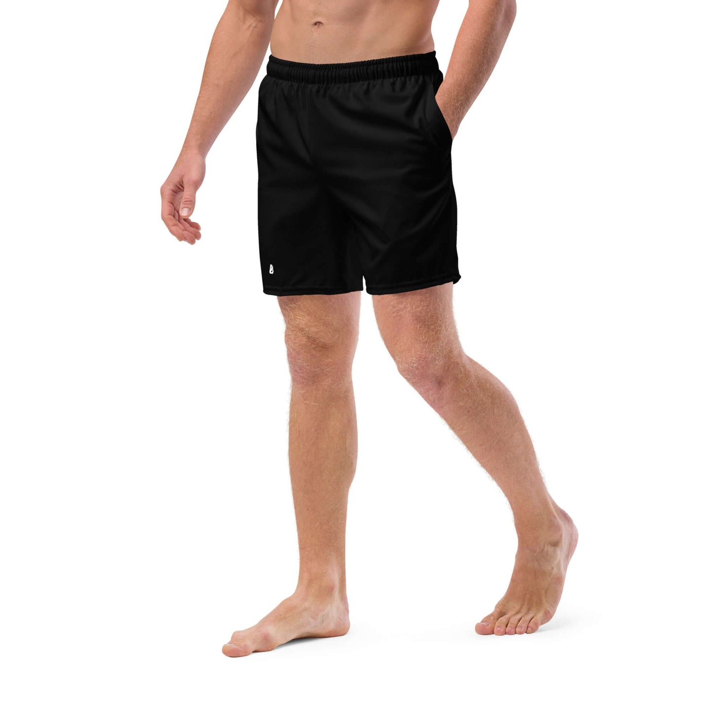 Man wearing Herren-Badehosen N°11, black quick-dry swim shorts with pockets, made from recycled polyester, ideal for summer.