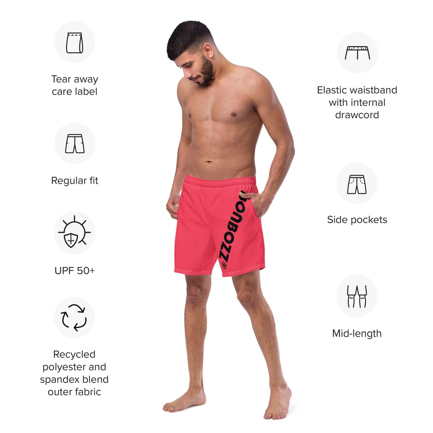 Model wearing Herren-Badehosen N°13 with elastic waistband, side pockets, UPF 50+ protection, and tear-away care label.