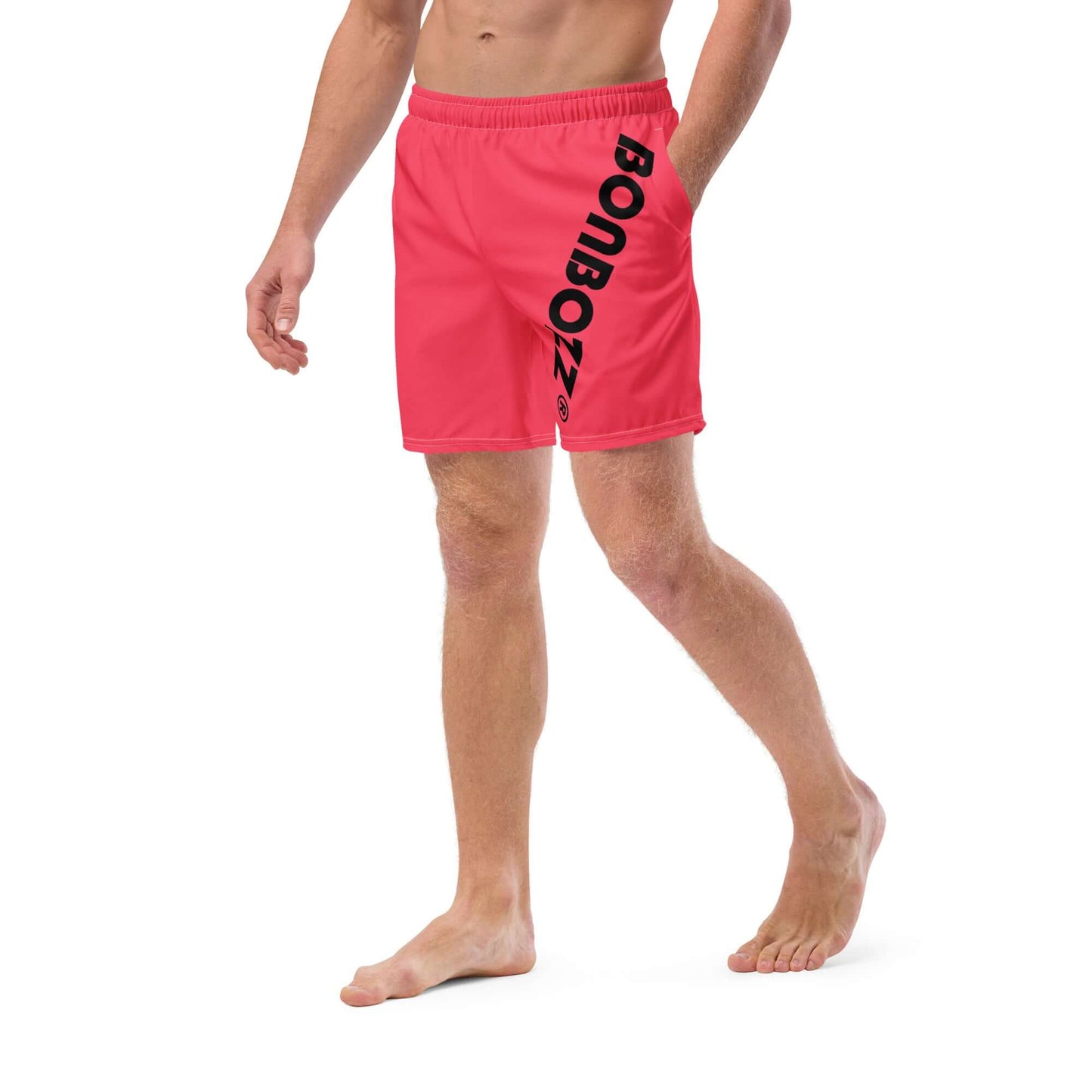 Man wearing Herren-Badehosen N°13 in red with logo print, featuring quick-dry and breathable fabric ideal for summer.