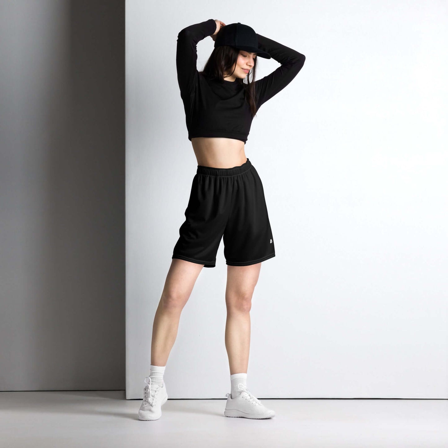 Model wearing Unisex Mesh-Shorts N°0 in a stylish pose, showcasing flexibility and comfort ideal for gym and casual wear.