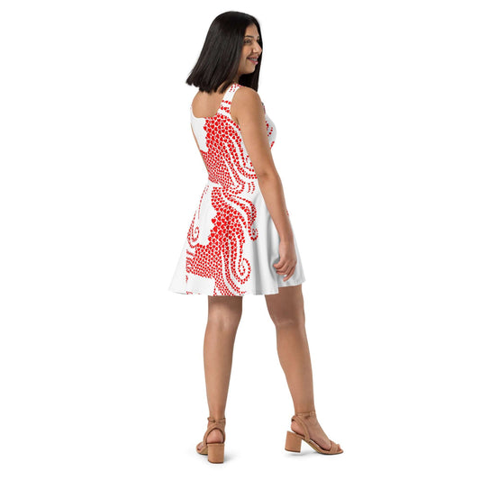 Woman wearing Skater-Kleid N°7 with red pattern, sleeveless design and flared mid-length skirt.
