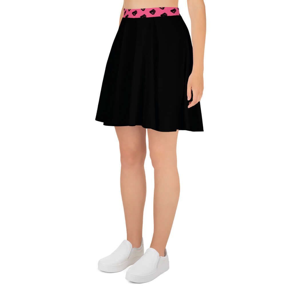 Woman wearing Skater-Rock N°10, black flared skirt with pink waistband, showcasing a flattering silhouette and soft fabric.