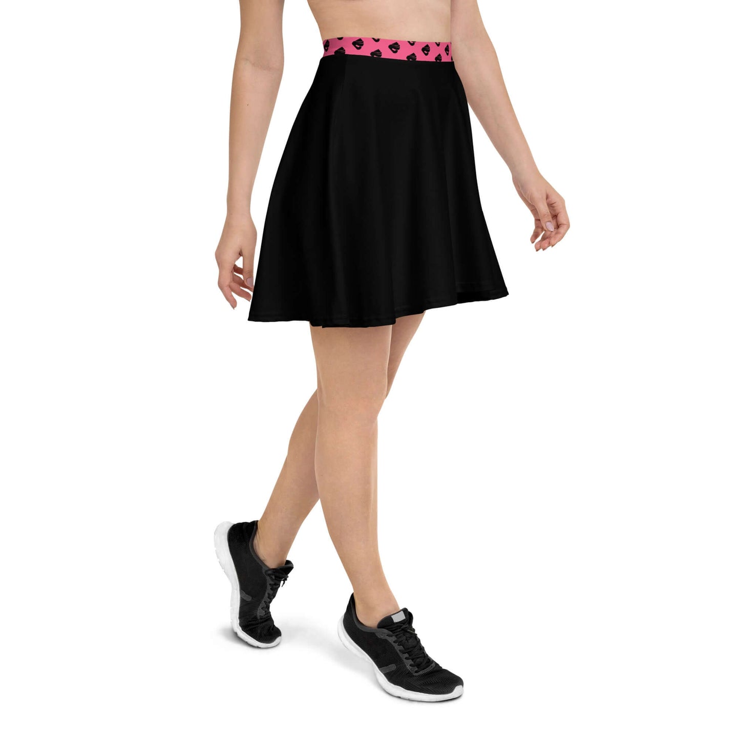 Woman wearing Skater-Rock N°10, black skirt with pink waistband, showcasing comfortable fit and flattering silhouette.