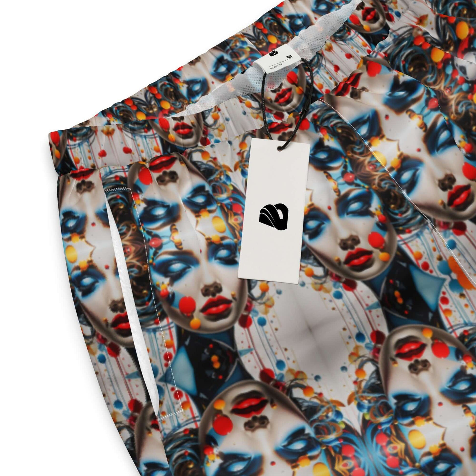 Colorful patterned fabric close-up with abstract faces and hanging tag for art-inspired clothing.