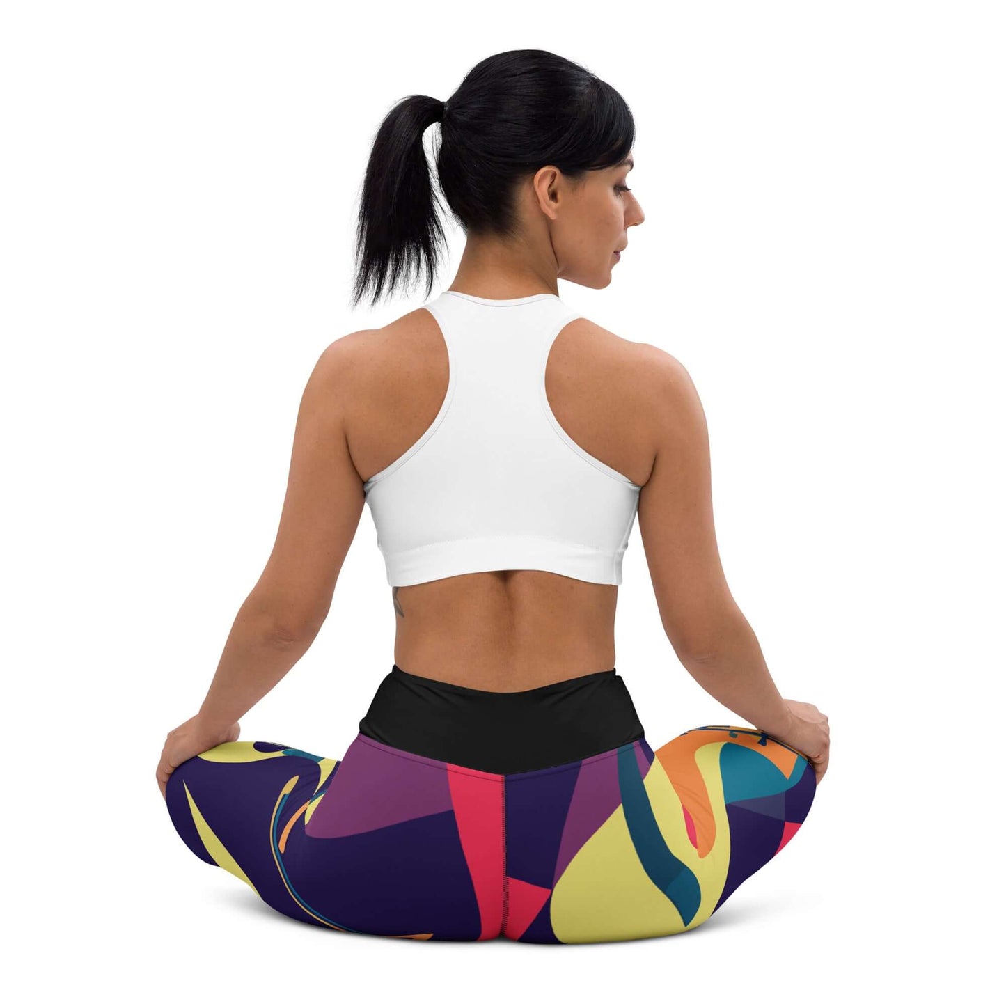 Woman in colorful Yoga-Leggings N°46 practicing yoga, showcasing flexibility and comfort with high-rise waistband and four-way stretch fabric.