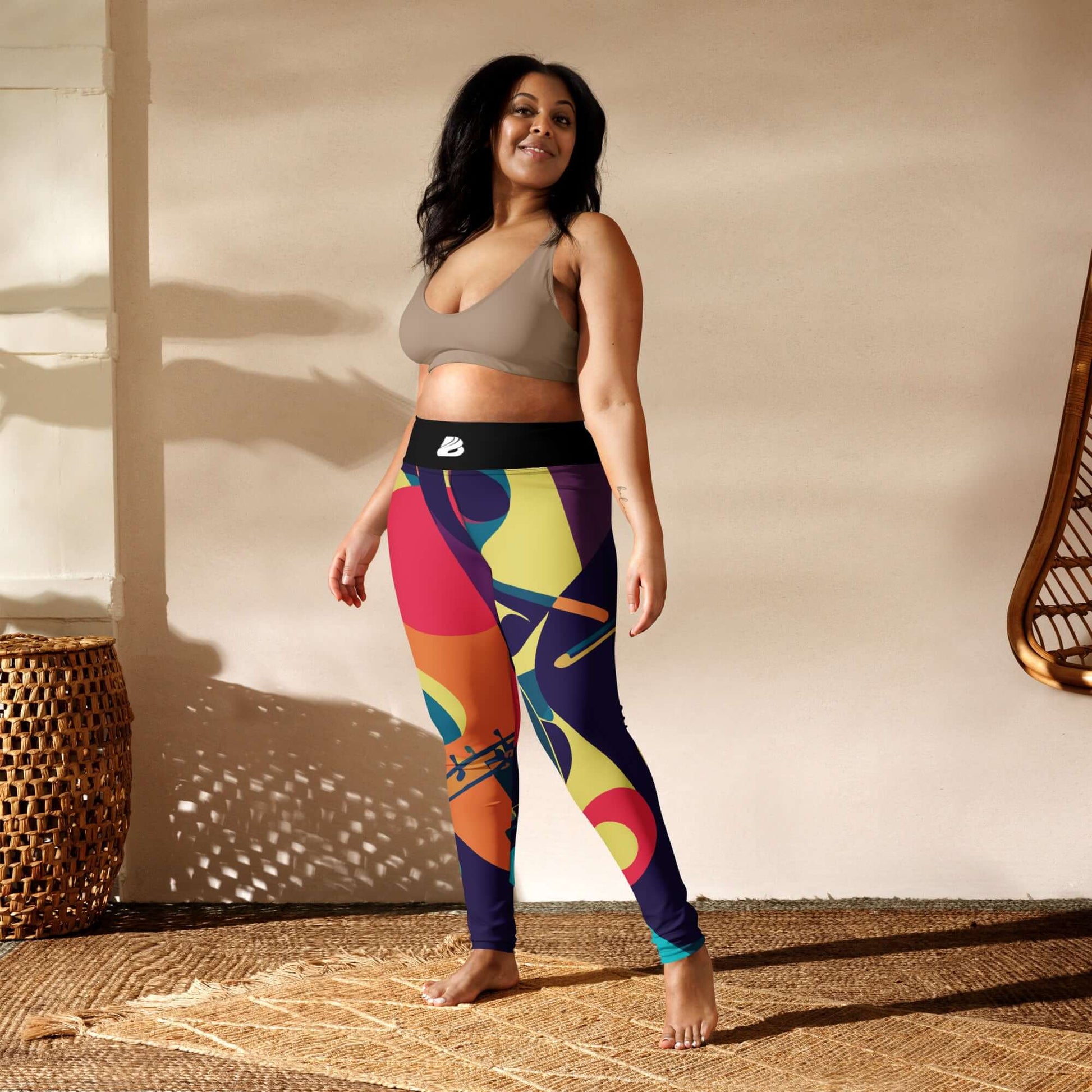 Woman wearing colorful Yoga-Leggings N°46 with high waist and four-way stretch in a serene room setting.