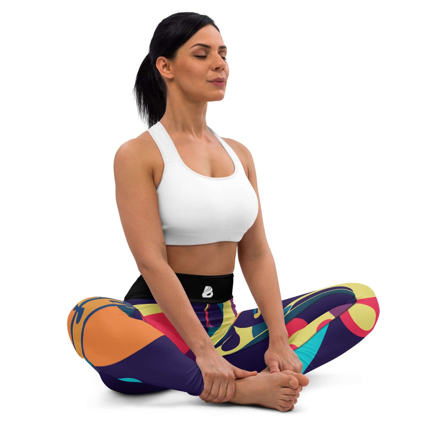 Woman wearing colorful Yoga-Leggings N°46 practicing yoga in colorful high-waisted leggings with four-way stretch, sitting pose.