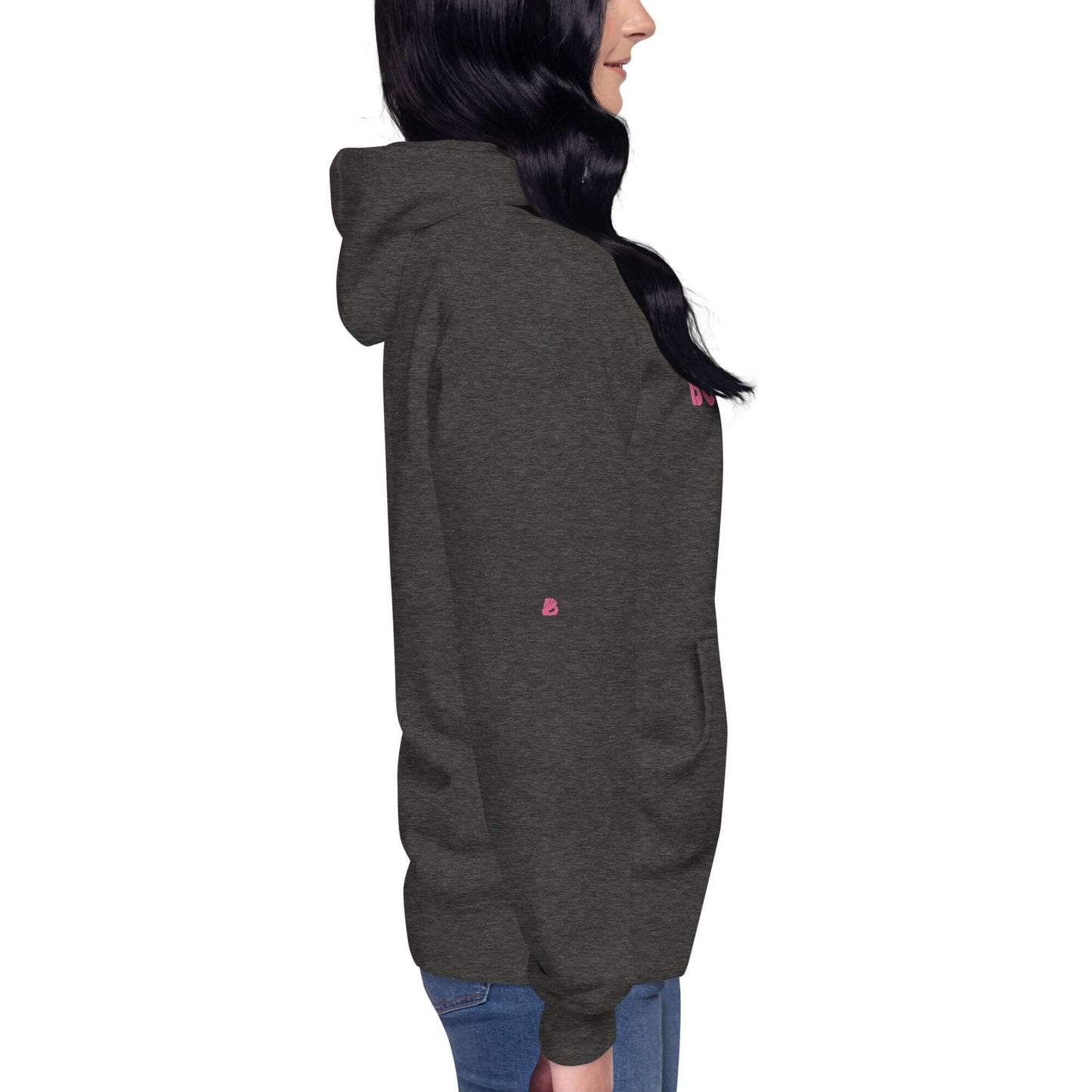 Person wearing dark gray Unisex-Kapuzenpullover with front pocket and hood, side profile view.