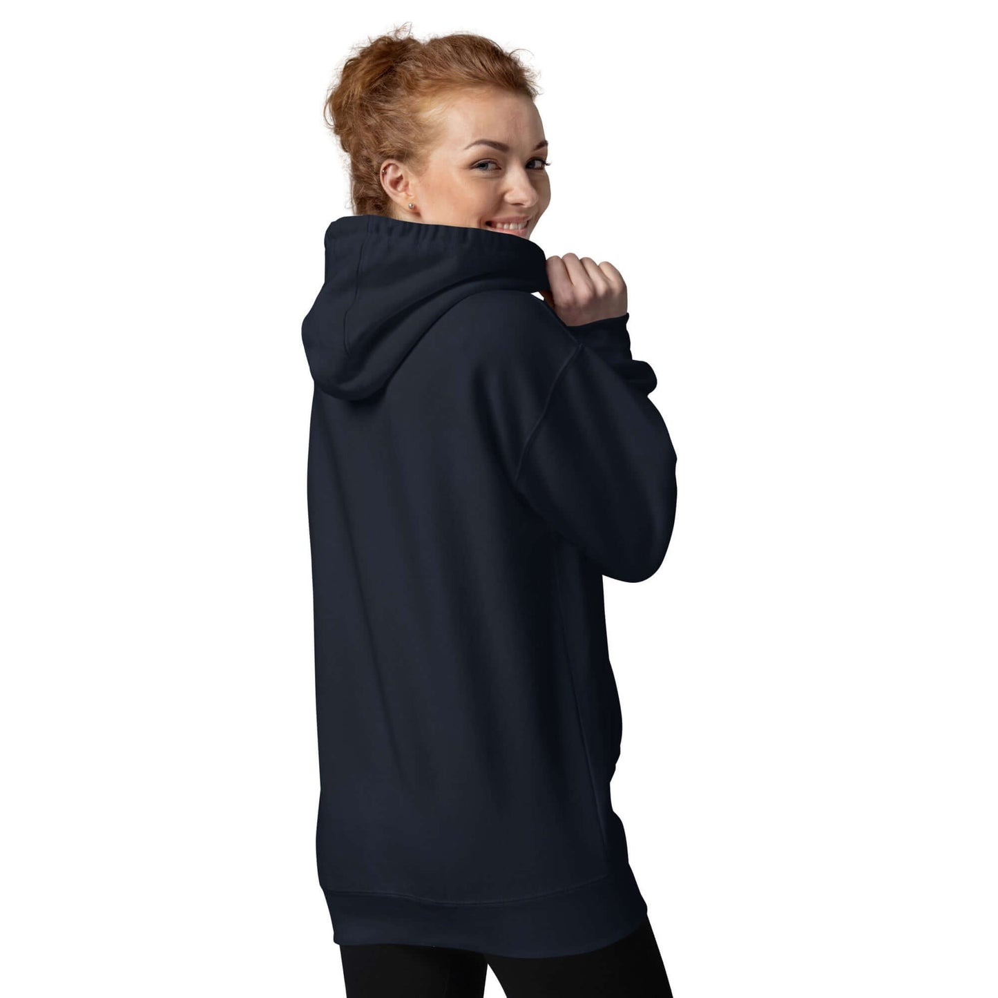 Model wearing navy Unisex-Kapuzenpullover with hood up and smiling back at the camera, displaying cozy streetwear style.