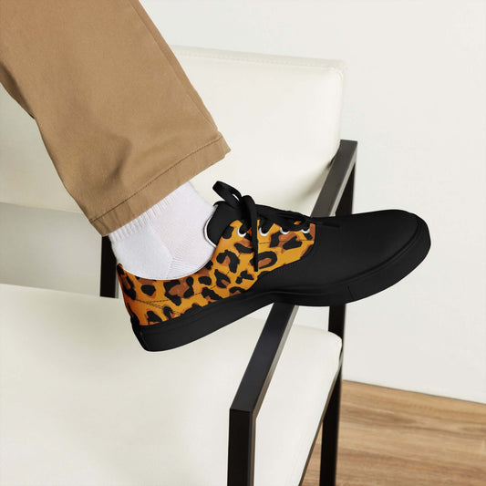 Person wearing Herren-Canvas-Schuhe with animal print design sitting on a chair, showcasing versatile everyday style.