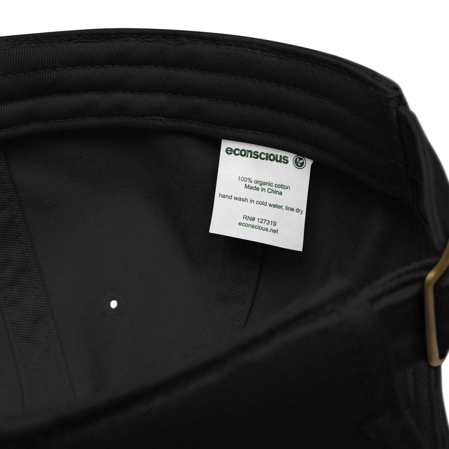 Interior tag of Bio-Dad Hat N°1 showing 100% organic cotton label and care instructions.