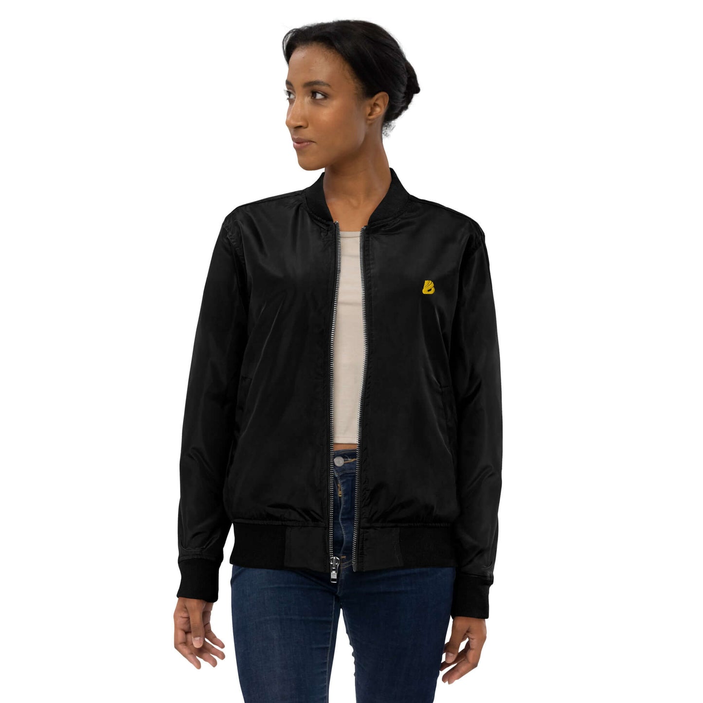 Stylish woman wearing a premium recycled bomber jacket in black, featuring a relaxed fit and utility pocket.