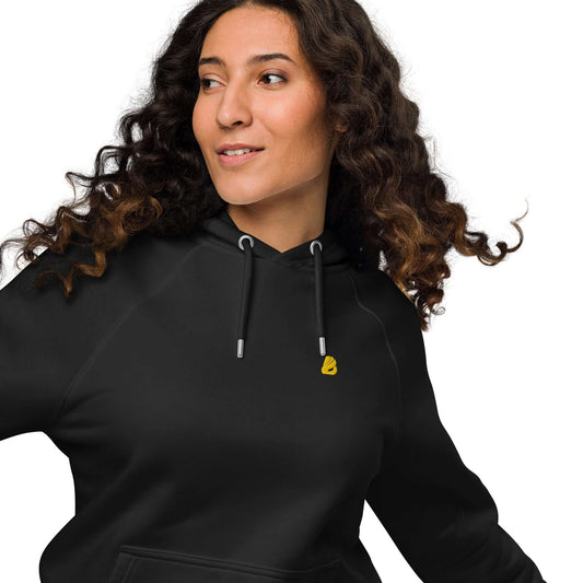 Model wearing Unisex Bio-Raglan-Hoodie N°5 in black, showcasing its comfort and versatile style for casual or dressed-up looks.