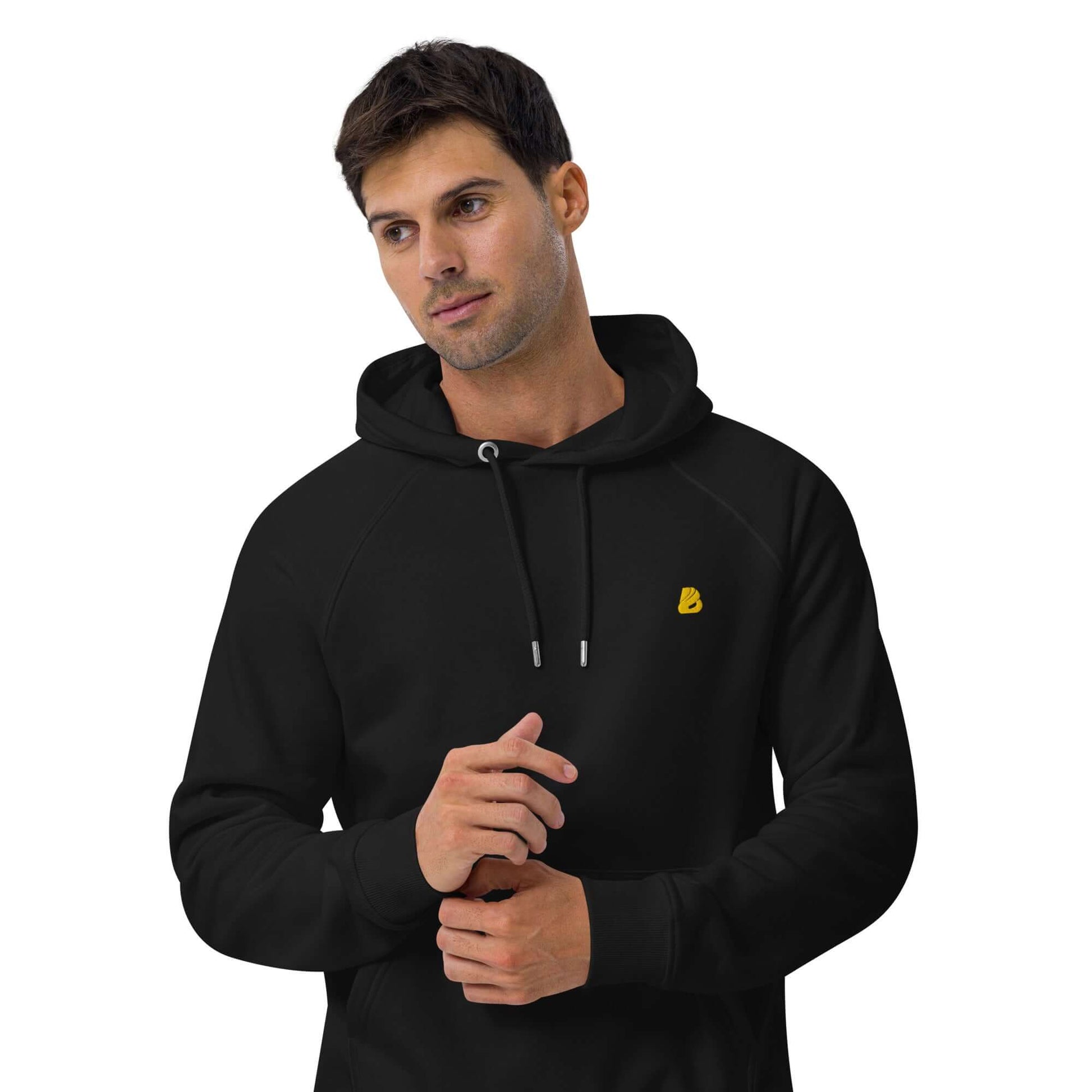 Man wearing Unisex Bio-Raglan-Hoodie N°5 in black, stylish and comfortable fashion choice.