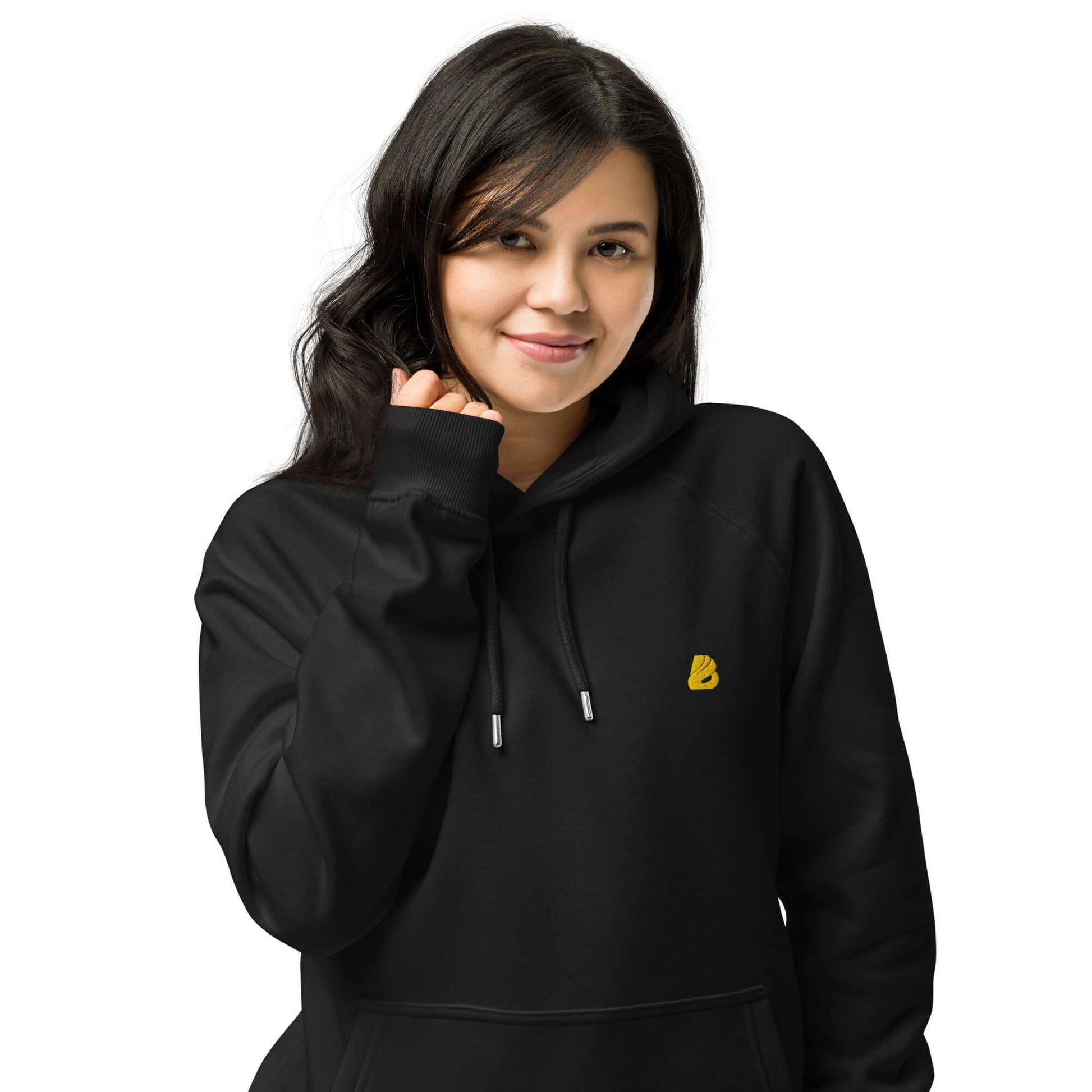 Woman wearing a black Unisex Bio-Raglan-Hoodie N°5 with a yellow logo, comfortable and stylish for casual or upgraded looks.