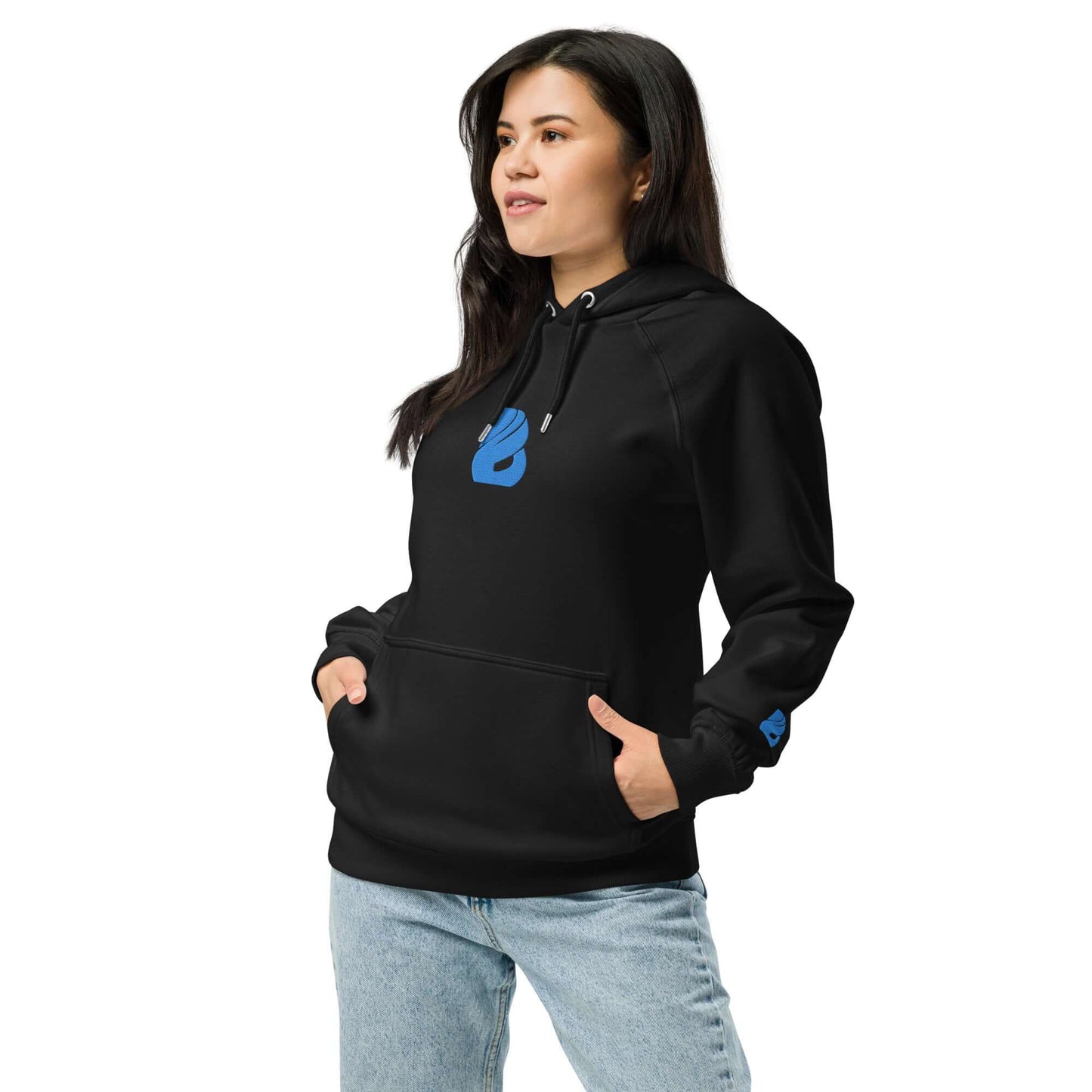 Woman wearing Unisex Bio-Raglan-Hoodie N°3, black with blue logo, paired with jeans for a casual look.
