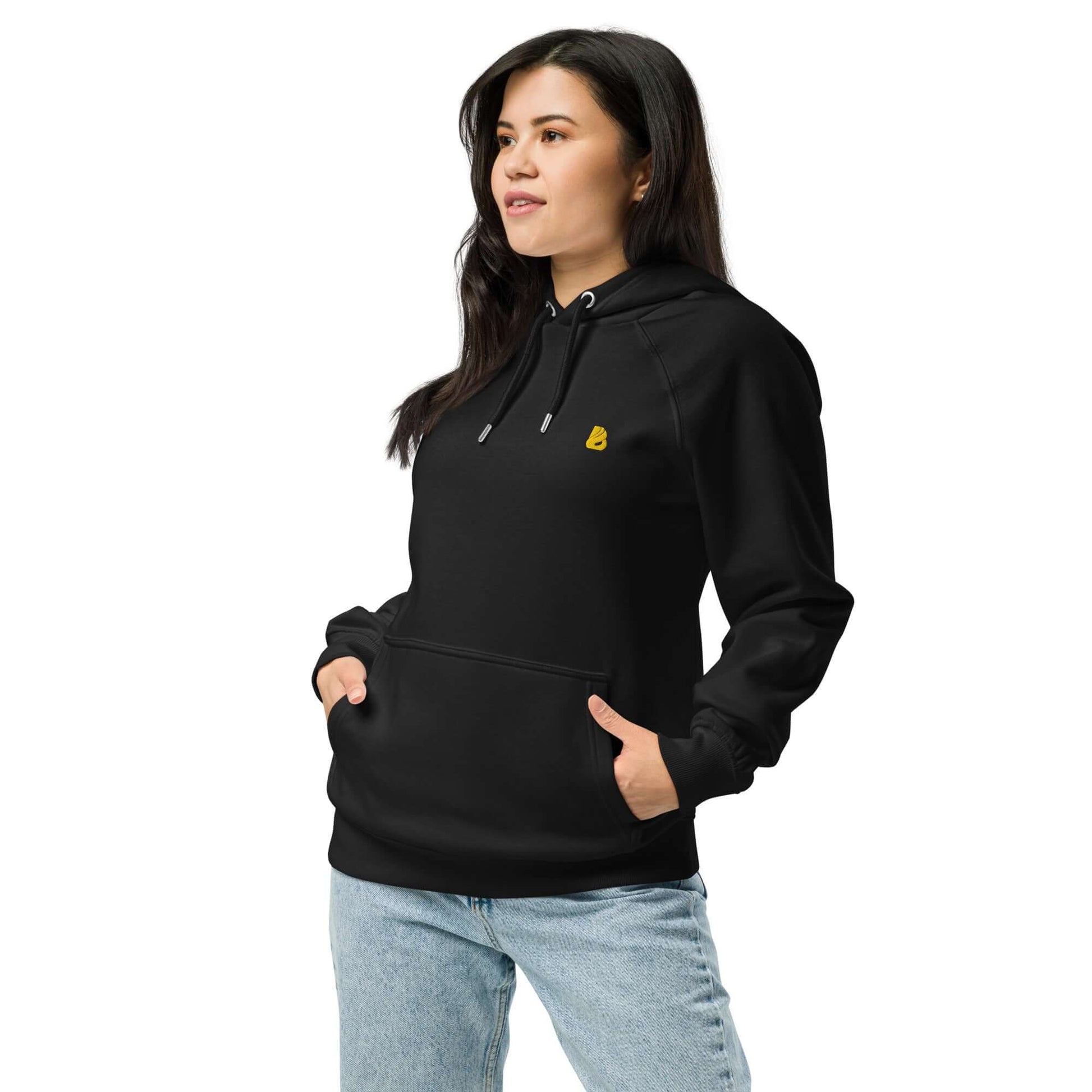 Model wearing Unisex Bio-Raglan-Hoodie N°5 in black with jeans, showcasing a comfortable and casual look.