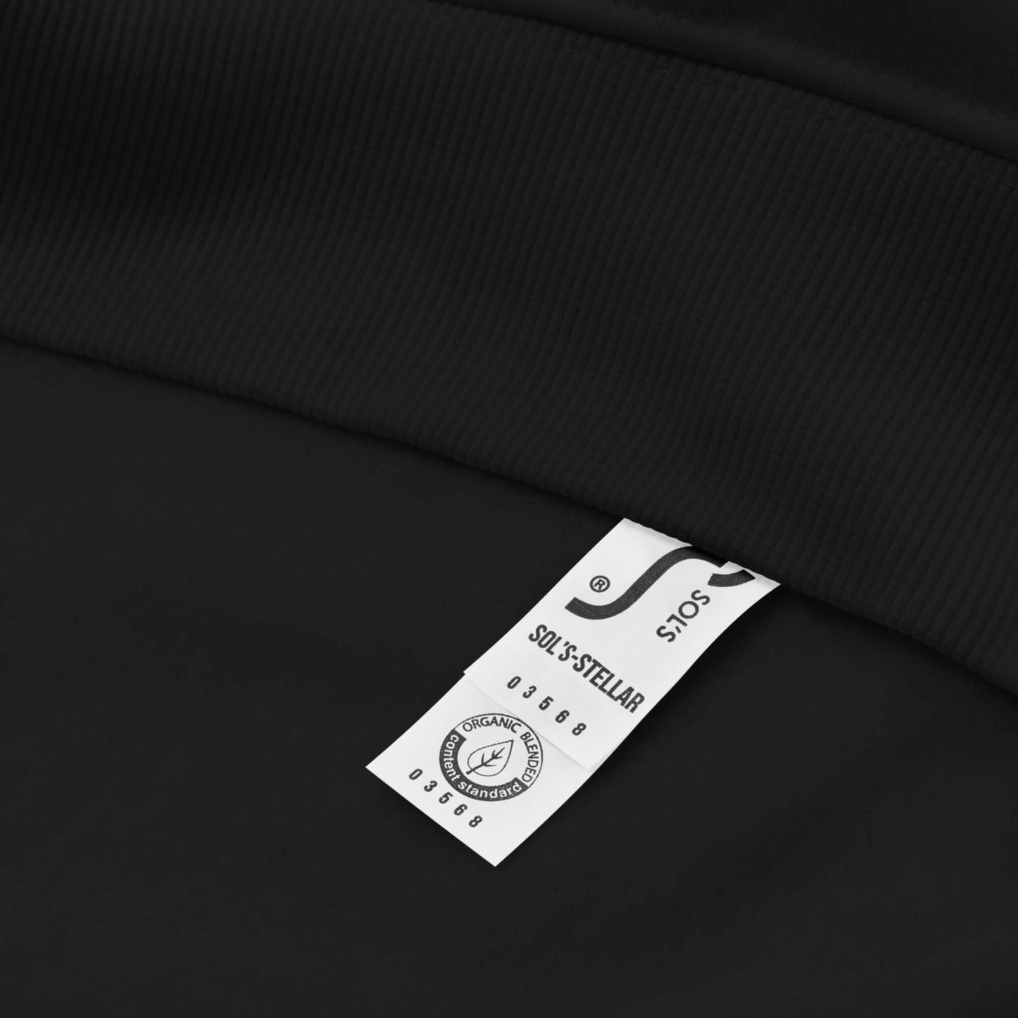 Label on black Unisex Bio-Raglan-Hoodie N°3 showing fabric and care instructions.