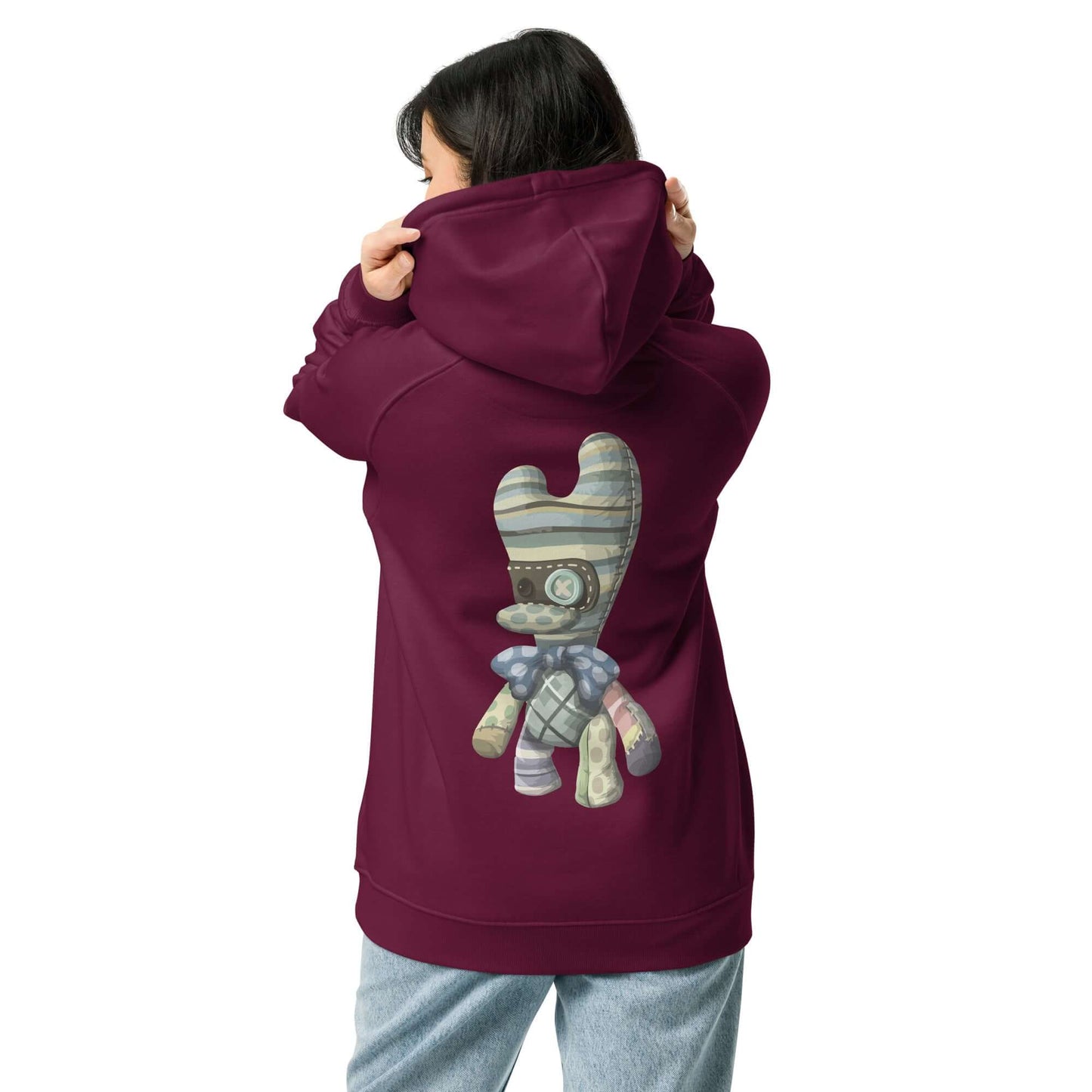 Person wearing Unisex Bio-Raglan-Hoodie N°4 with a playful geometric design on the back, showcasing style and comfort.