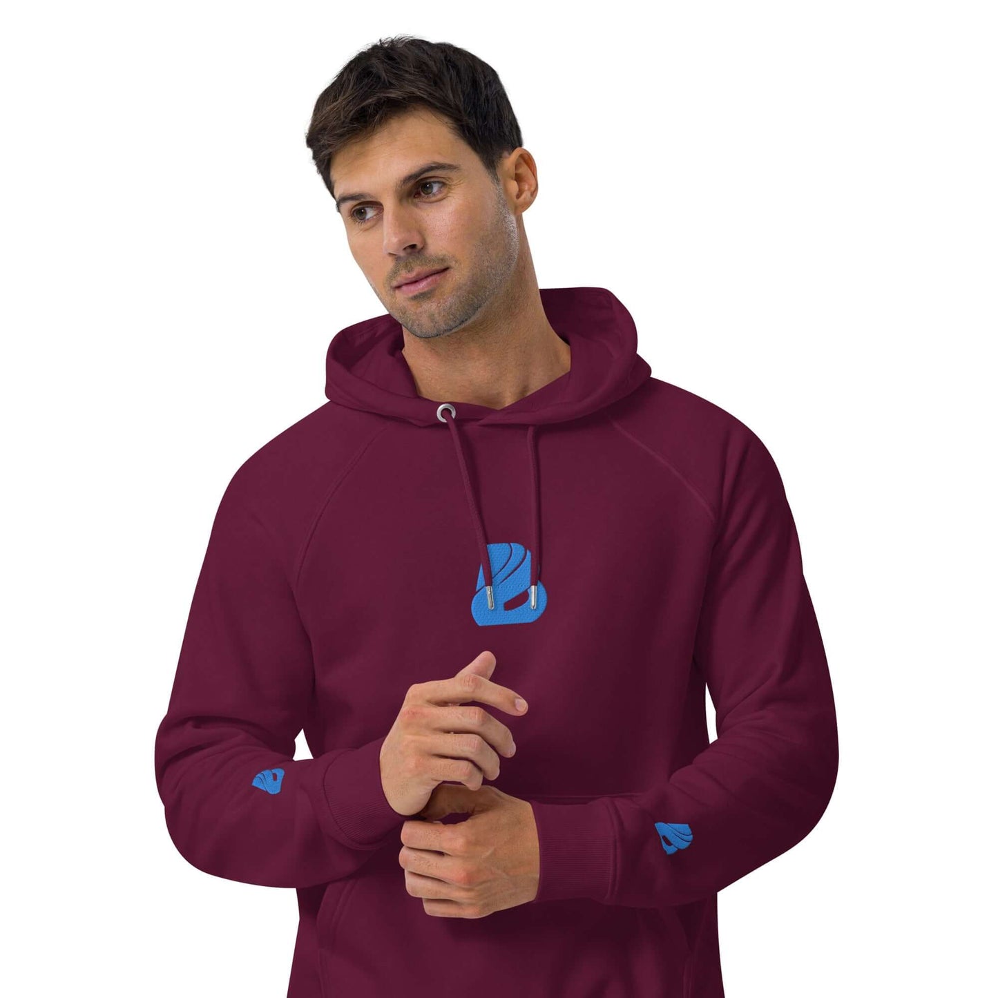 Man wearing maroon Unisex Bio-Raglan-Hoodie N°3 with blue logo, showcasing soft fabric and casual style.
