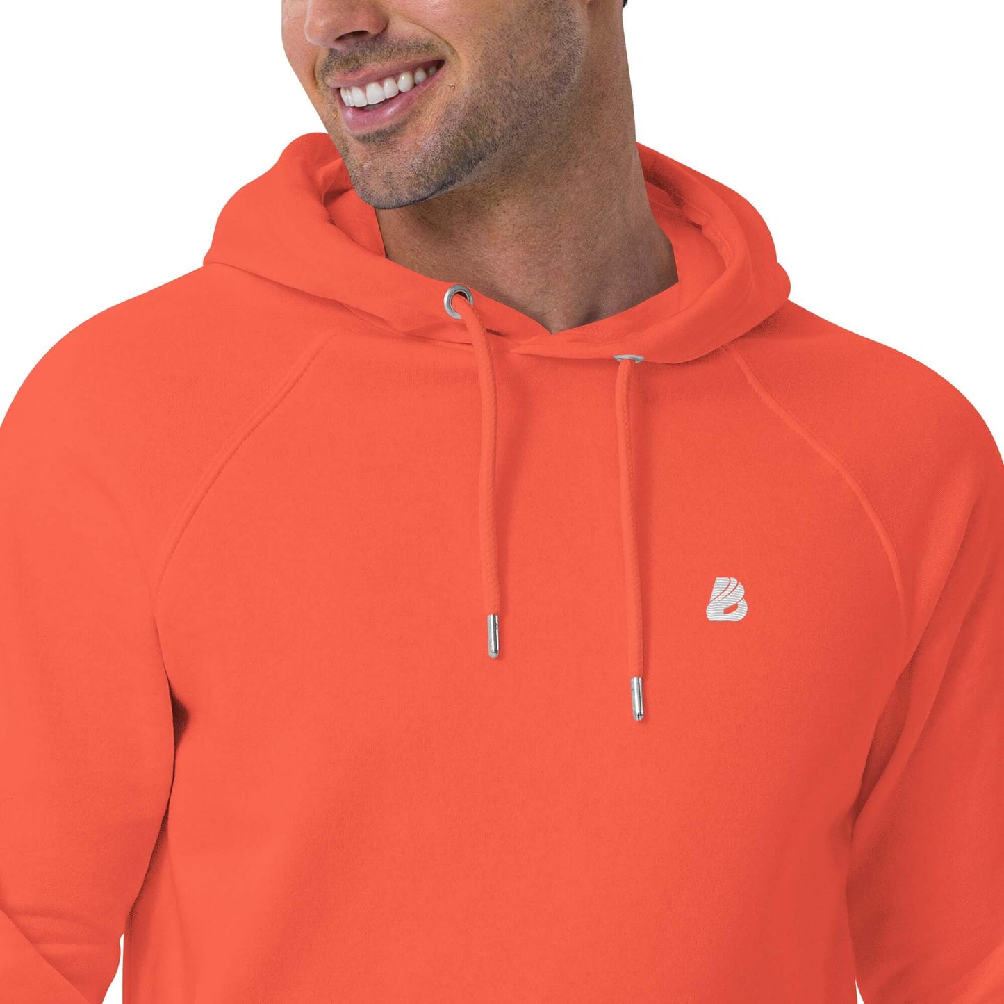 Smiling person wearing an orange Unisex Bio-Raglan-Hoodie N°4 with adjustable drawstrings