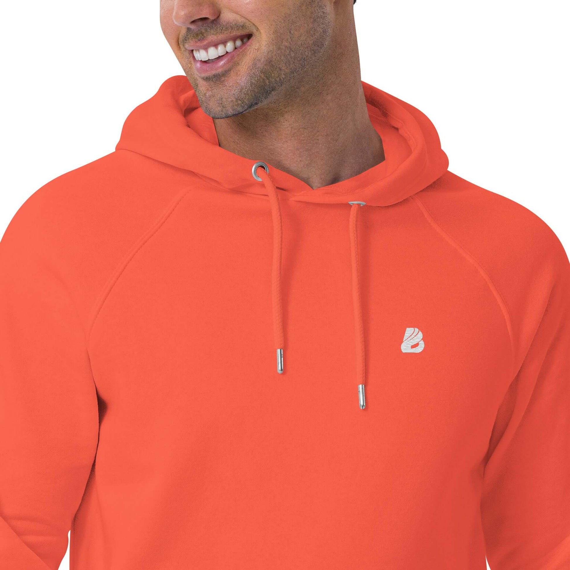Smiling person wearing an orange Unisex Bio-Raglan-Hoodie N°4 with adjustable drawstrings