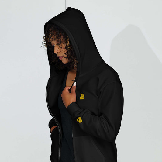 Person wearing Unisex Heavy-Blend Zip Hoodie N°0 in black with hood up, featuring front pockets and metal zipper, stylish and comfortable.