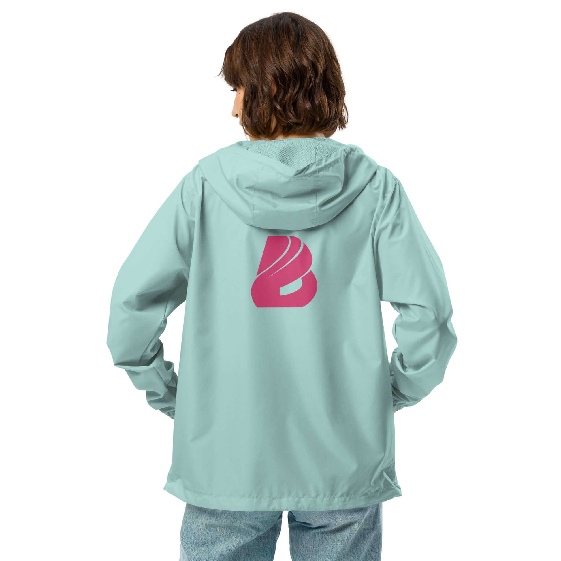Person wearing light blue Leichter Unisex-Windbreaker mit Reißverschluss, displaying pink logo on back, suitable for outdoor adventures.