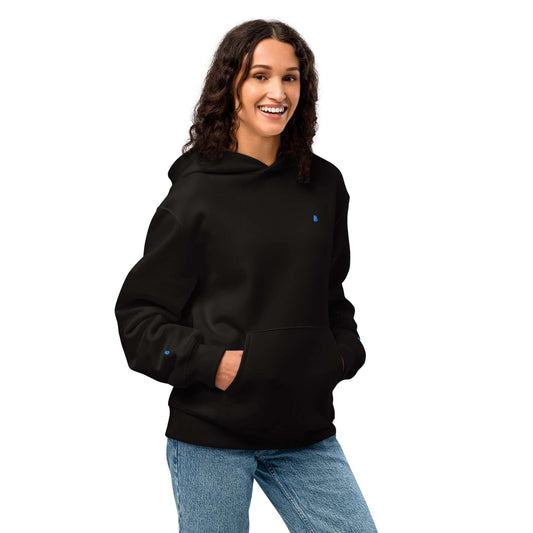 Schwerer Oversized Hoodie in black worn by a person, featuring soft fleece fabric for comfort and style.