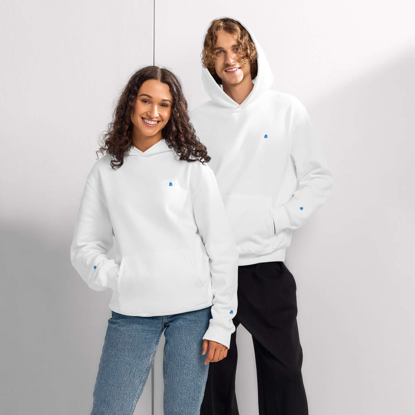 Two models wearing a white Schwerer Oversized Hoodie with breathable cotton fabric, showcasing modern style and ultimate comfort.