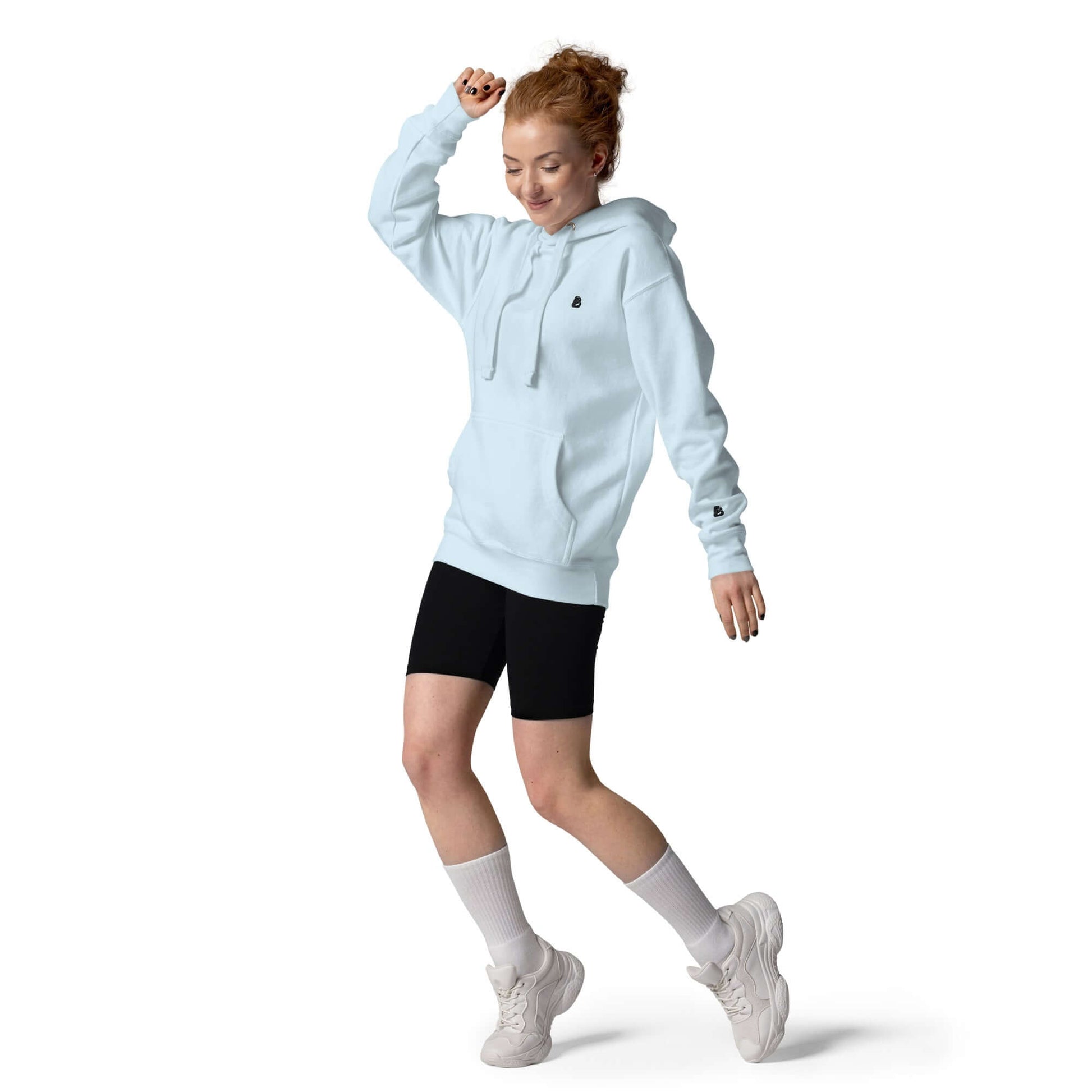 Person wearing Unisex-Kapuzenpullover N°49 in light blue, showcasing style and comfort of the soft hoodie with pouch pocket and warm hood.
