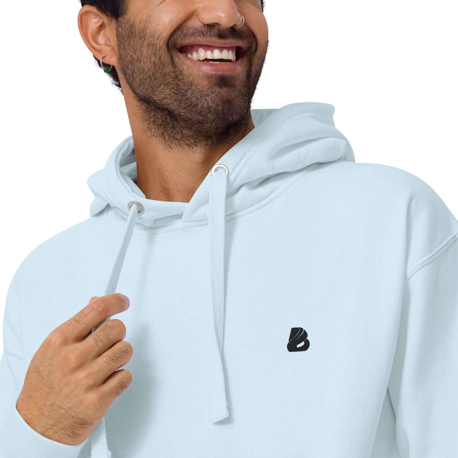 Man wearing Unisex-Kapuzenpullover N°49 with logo, soft cotton blend, front pocket, and cozy hood, ideal for cool evenings.