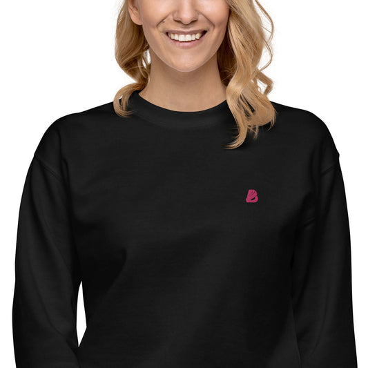 Unisex-Premium-Pullover N°1 in black with ribbed crew neckline, showing soft fleece interior. Stylish and comfortable for everyday wear.
