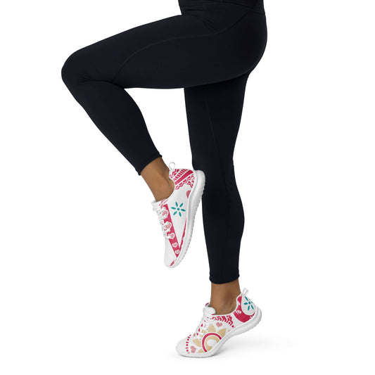 Person wearing Damen-Turnschuhe N°2 with colorful pink design, performing a leg stretch exercise.