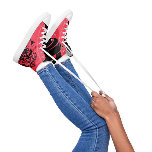 Person wearing red and black High-Top Leinenschuhe für Damen N°3 while lacing up shoes, showcasing stylish high-profile design.