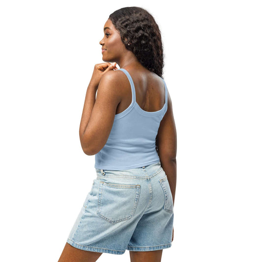 Woman wearing Damen Tanktop mit feiner Rippstruktur N°1 in light blue, paired with denim shorts, showing a versatile summer fashion style.