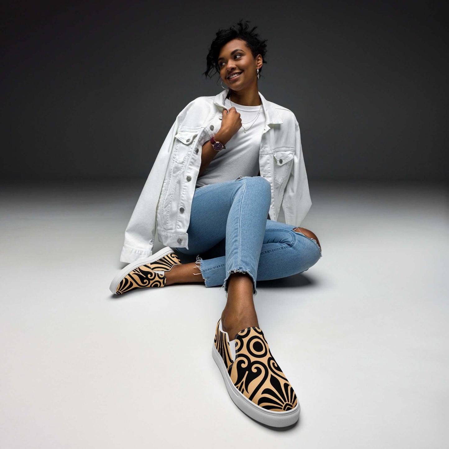 Model wearing Damen-Canvas-Slipper N°0 with unique pattern, showcasing comfort and style for women, denim outfit, studio background.