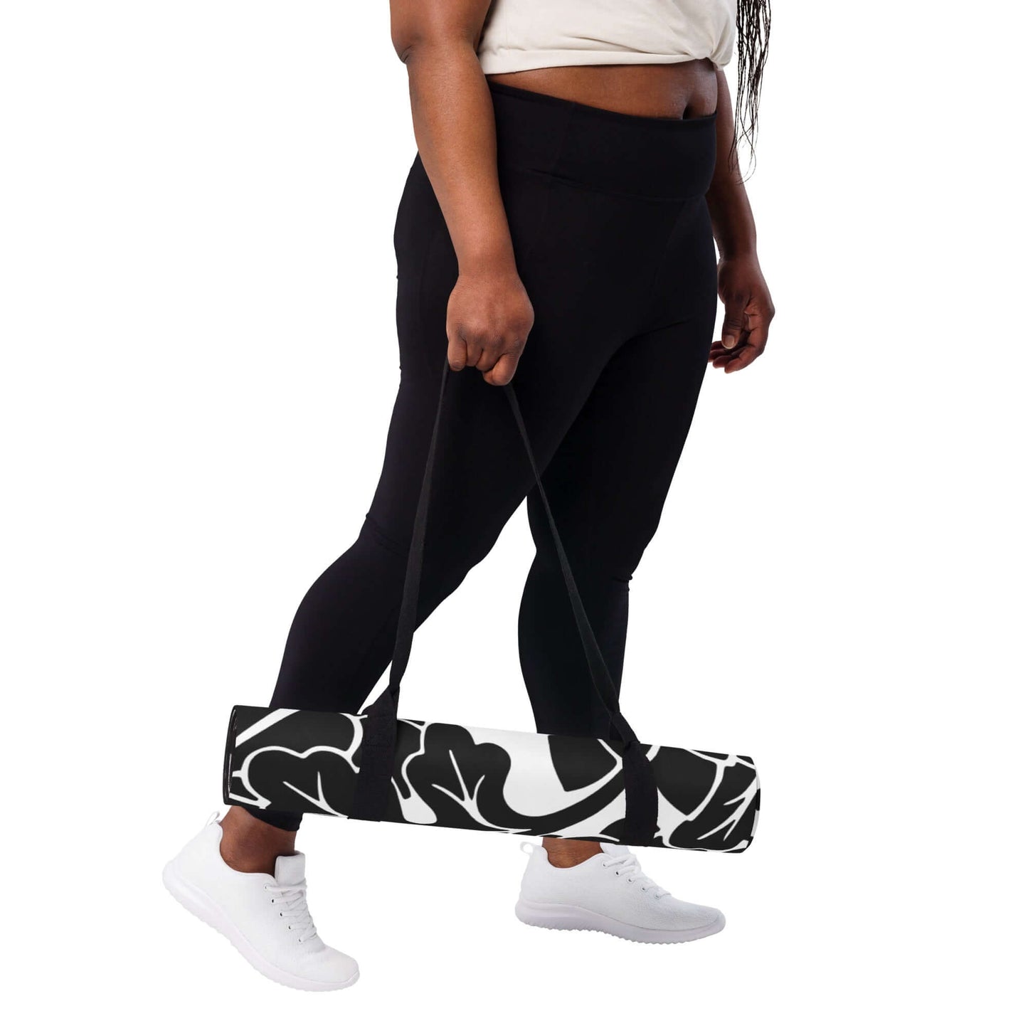 Person carrying rolled Yoga-Matte N°0 with black and white design, includes rutschfester Gummiboden, easy transport.