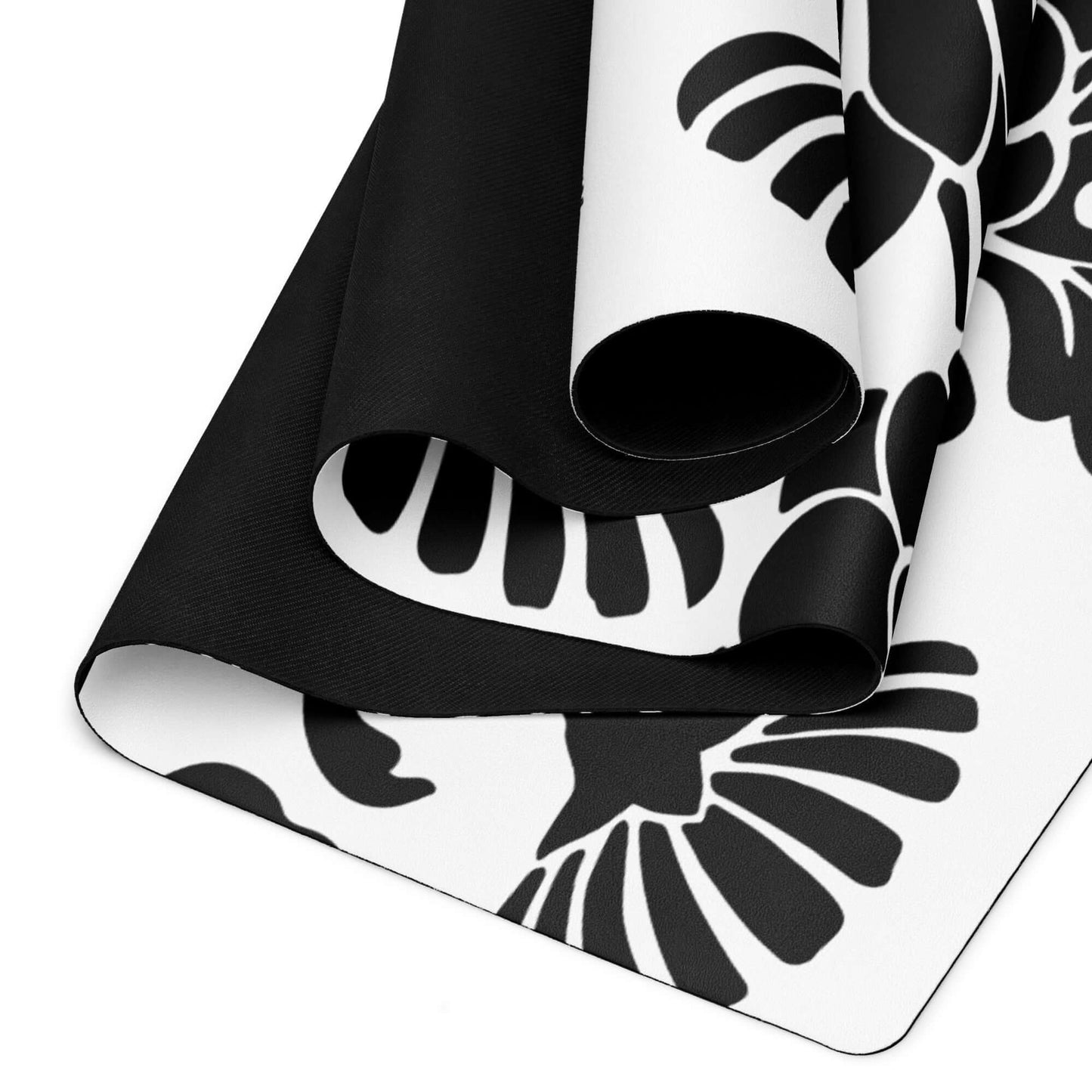 Yoga-Matte N°0 in black and white with non-slip rubber and soft microvelour surface rolled up, ideal for stability and comfort. Size: 61cm x 173cm.